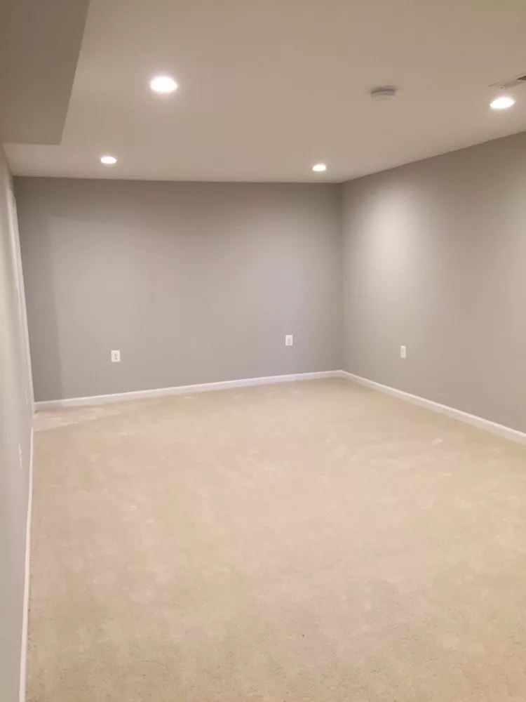 Finished room with recessed lighting and new carpet