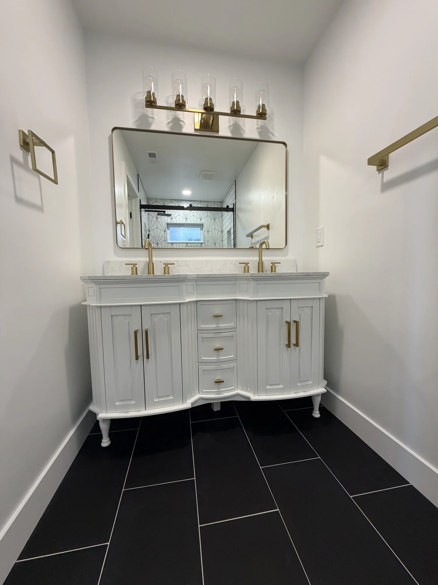 Custom bathroom vanity with brass fixtures and quartz top