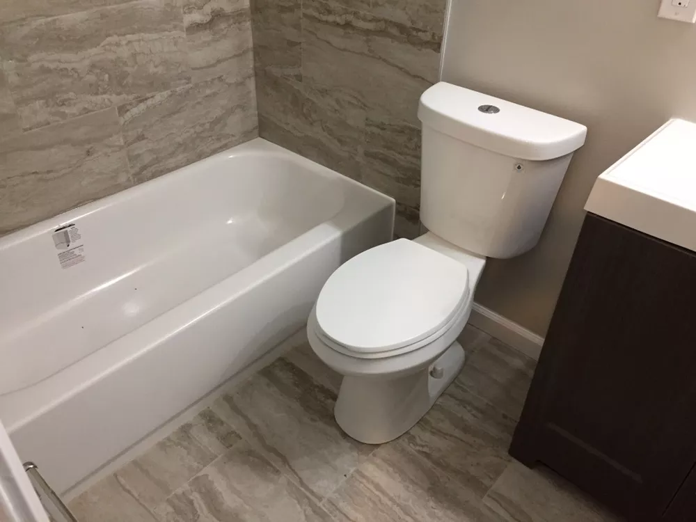 Bathtub, toilet and vanity in a completed bathroom remodel